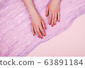 Woman hands with manicure and satin 63891184