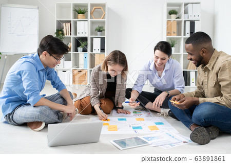Young specialists working on startup project 63891861