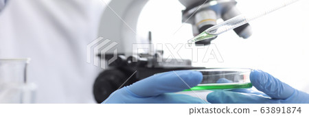 Microscopic examination particles, gloved hands Microscopic examination particles, gloved hands 63891874