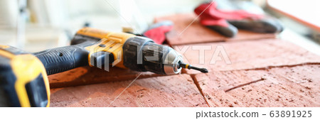 Screwdriver lies bricks, construction and repair Screwdriver lies bricks, construction and repair 63891925