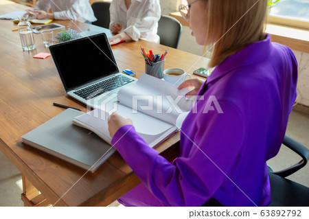 Business young caucasian woman in modern office with team Business young caucasian woman in modern office with team 63892792