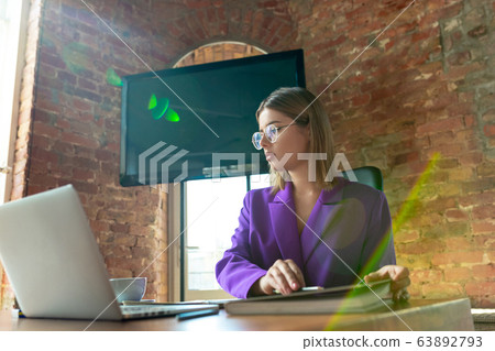 Young caucasian business woman working in office, diversity and girl power concept Young caucasian business woman working in office, diversity and girl power concept 63892793