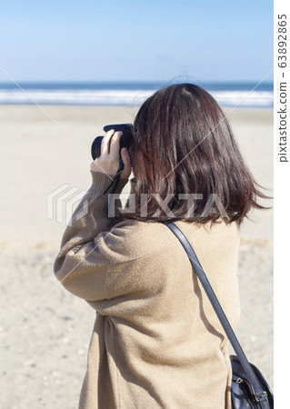 A woman taking a picture A woman taking a picture 63892865