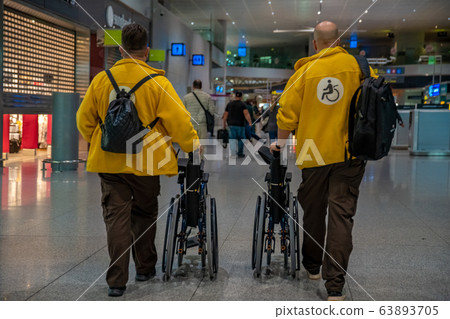 transport of the disabled on wheelchairs at the airport by the assistance service transport of the disabled on wheelchairs at the airport by the assistance service 63893705