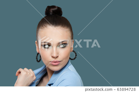 Perfect woman brunette looking aside on blue 63894728