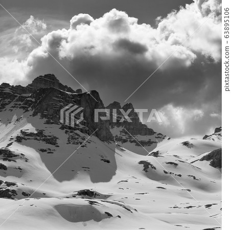 Snowy mountains and cloudy sky in winter evening Snowy mountains and cloudy sky in winter evening 63895106