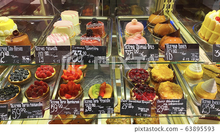 Cupcakes of different types on a shop window. Cupcakes of different types on a shop window. 63895593