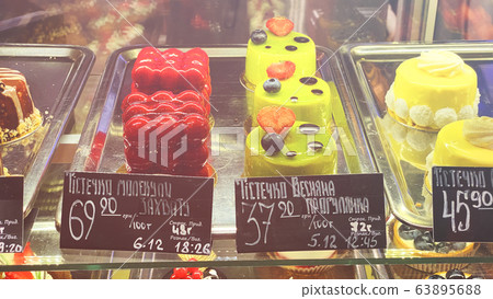 Cupcakes of different types on a shop window. Cupcakes of different types on a shop window. 63895688