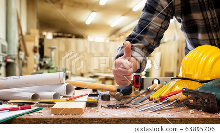 Carpenter at work in the carpentry workshop. 63895706