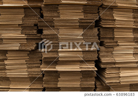 Supply of unassembled cardboard boxes in the warehouse. Stack of unpacked not assembled cardboard box. 63896183