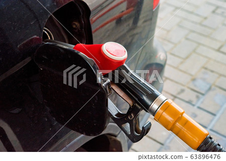 Refilling the car with fuel on a gas station Refilling the car with fuel on a gas station 63896476