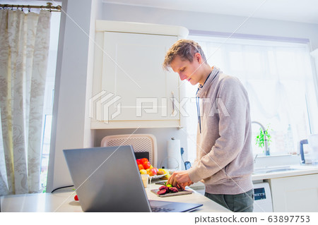 Young caucasian man working from home. Freelancer Young caucasian man working from home. Freelancer 63897753