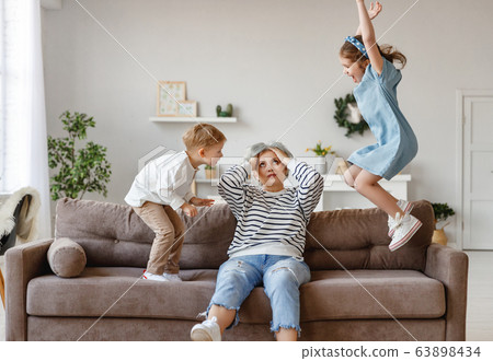 Senior woman with grandchildren at home. 63898434