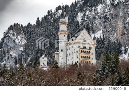 The royal castle Neuschwanstein in Bavaria, Germany (Deutschland). The famous Bavarian place sign at winter day, clouds sky 63900046