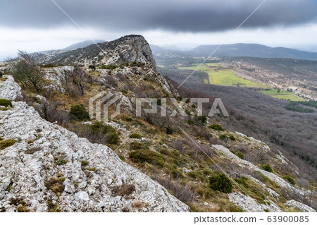 The mountain over grotto of Mary Magdalene at cloudy weather, clouds over a valley, a dry grass 63900085