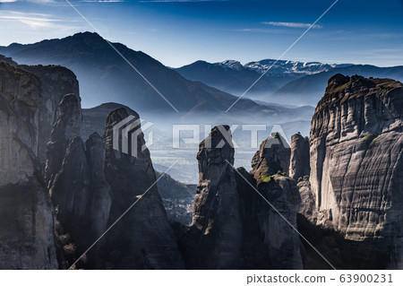 Aerial view of Unesco monument Meteora, the mountains, the landmark of Greek, sunny weather, fog, haze over a valley 63900231