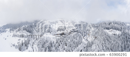 Aerial View of the Landwasser Viaduct with Railway without famous train at winter, landmark of Switzerland, snowing, river and mountains Aerial View of the Landwasser Viaduct with Railway without famous train at winter, landmark of Switzerland, snowing, river and mountains 63900291