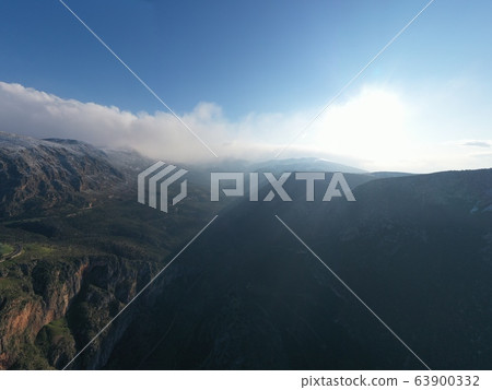 Aerial view of mountains at sunrise, Morning fog over mountains, Sun beams 63900332