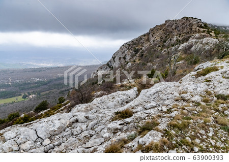 The mountain over grotto of Mary Magdalene at cloudy weather, clouds over a valley, a dry grass 63900393