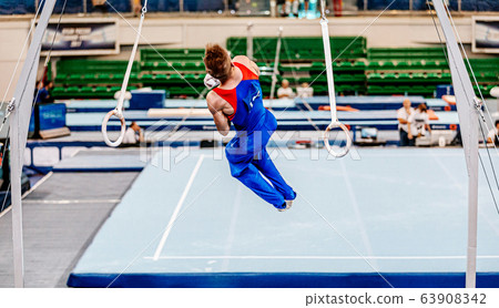 athlete gymnast dismounts on still rings athlete gymnast dismounts on still rings 63908342