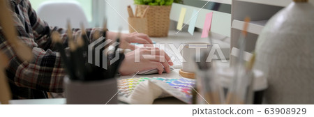 Side view of female graphic designer working with 63908929