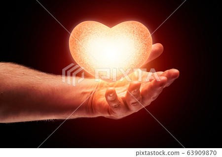 glow heart in hand 63909870