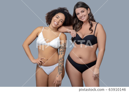 Two women in a good mood standing in underwear. 63910146