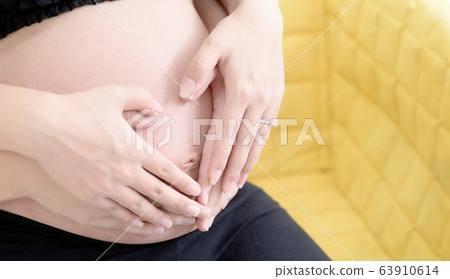 Close up couple hands male and female making heart 63910614