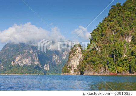 limestone Mountain and morning mist and beautiful view neture in the Cheow Lan dam Khao Sok National Park, Thailand 63910833