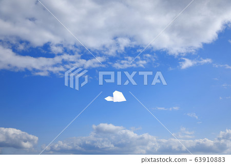 Paper airplane flying in the sky 63910883