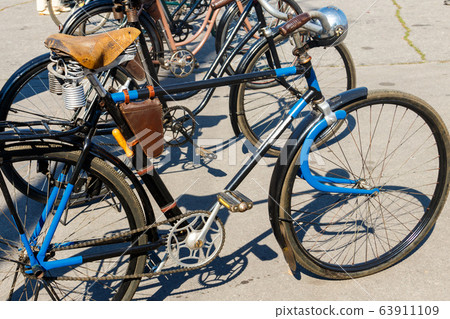 Old bicycles parked on city street Old bicycles parked on city street 63911109