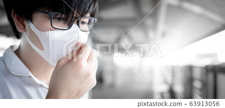 Asian man wearing mask at skytrain station Asian man wearing mask at skytrain station 63913056