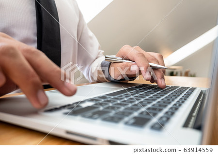 Close-up Of Young businesswomen working on laptop for online searching 63914559