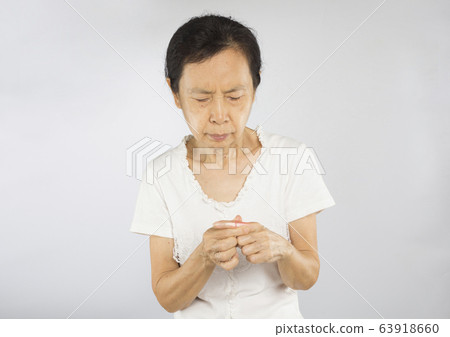 old asian woman feel finger bone pain  63918660