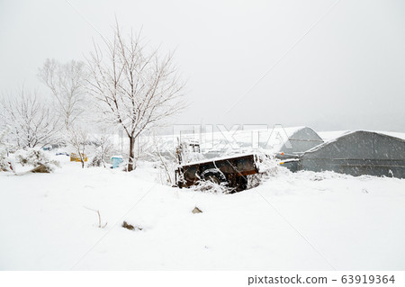 Snow covered rural farm village at Winter 63919364