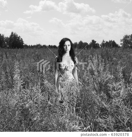 Lady in a flower meadow Lady in a flower meadow 63920378