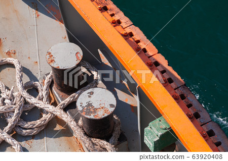 Bollard and  ropes are on a tug boat deck 63920408