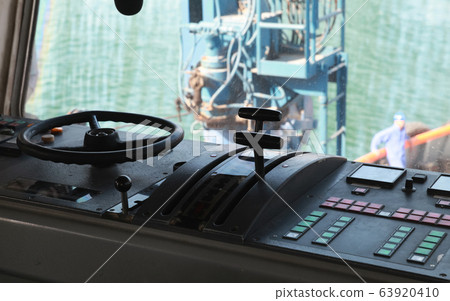 Control panel with steering wheel of a tug boat Control panel with steering wheel of a tug boat 63920410