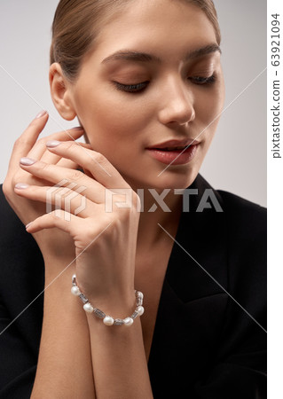 Young brunette model demonstrating jewelry. Young brunette model demonstrating jewelry. 63921094