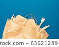 Wooden plates, forks, knives in paper bag for food 63921289