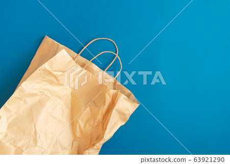 Crumpled Paper bag on a blue background 63921290