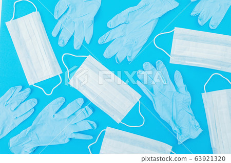 Medical masks for protection from virus and bacteria on a blue background. Flat lay Medical masks for protection from virus and bacteria on a blue background. Flat lay 63921320