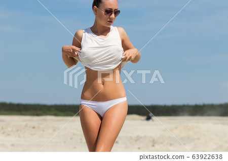 Sexy woman on windy day on beach Sexy woman on windy day on beach 63922638