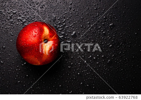 Nectarine fruit isolated on wet black background. 63922768