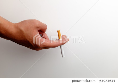 Hand holding a cigarette 63923634