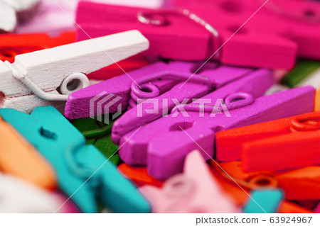 Small Clothespins of different colors close-up as 63924967