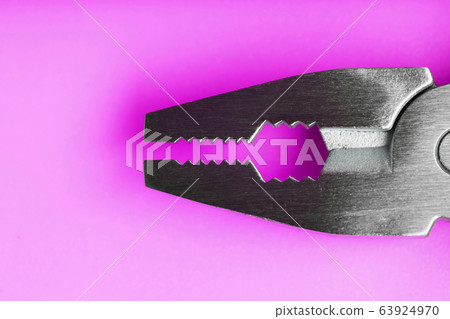 Multitool is a multi-functional tool on a pink Multitool is a multi-functional tool on a pink 63924970