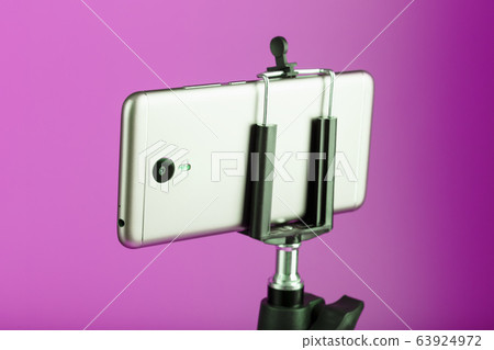 Smartphone on a tripod as a photo-video camera on Smartphone on a tripod as a photo-video camera on 63924972