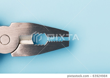 The multitool multi-function tool hovers on a blue 63924984