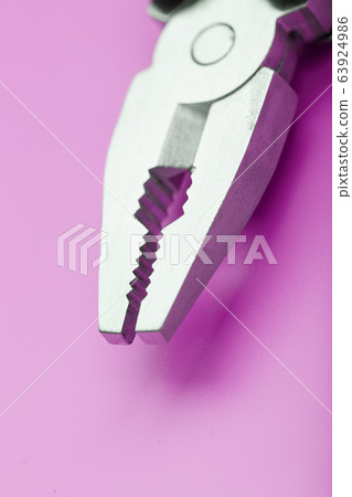 Multitool is a multi-functional tool on a pink Multitool is a multi-functional tool on a pink 63924986